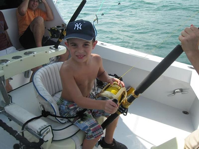 kid holding a fishing hook