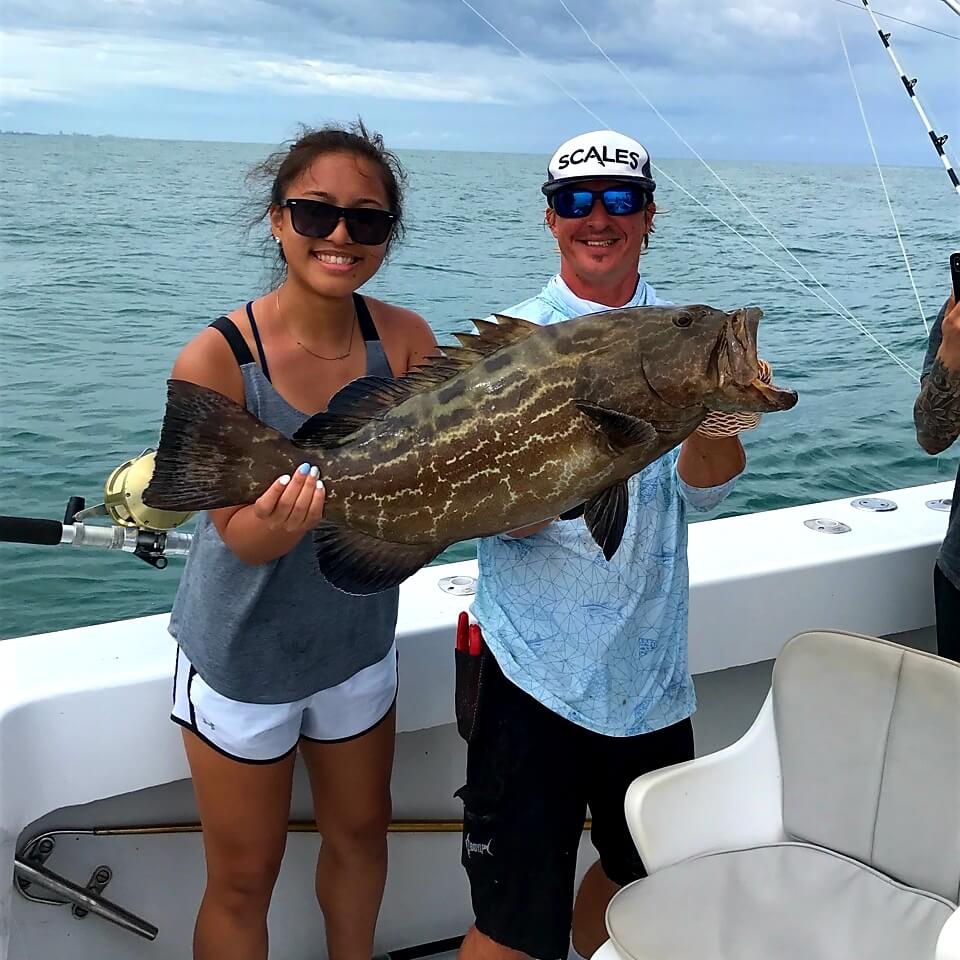 Girl holding Groupers fish